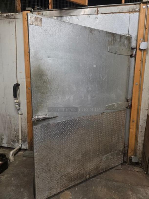 Metal walk-in door with hardware, featuring diamond plate lower half. Used condition, sturdy hinges, and secure handle.
