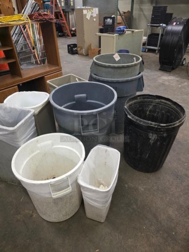Lot of miscellaneous trash cans in various sizes and colors, including white, gray, and black. Some have lids, used condition.