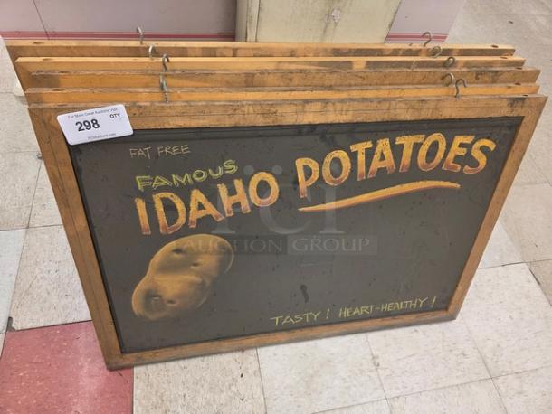 Lot of 5 vintage signs promoting "Famous Idaho Potatoes," with wood frames. Signs feature text and potato graphics, good condition.