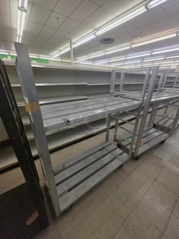 Aluminum mobile shelf cart with three tiers, durable design, caster wheels for easy movement, in good condition.