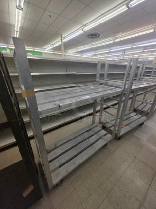 Aluminum mobile shelf cart with three tiers, durable design, caster wheels for easy movement, in good condition.