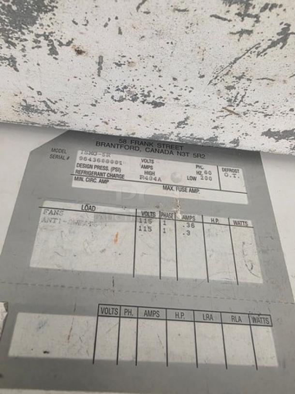 Label on Hussmann ISMG-5R Refrigerator Island Merchandiser, showing model, volts, amps, refrigerant type, and other specs.