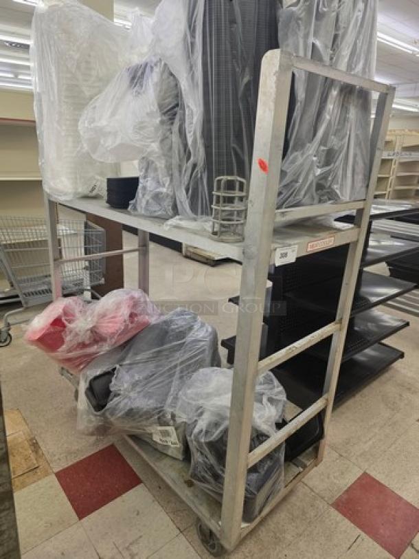 Aluminum mobile cart with two shelves and wheels, lightly used, showing sturdy construction. Contents not included.