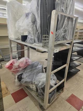 Aluminum mobile cart with two shelves and wheels, lightly used, showing sturdy construction. Contents not included.