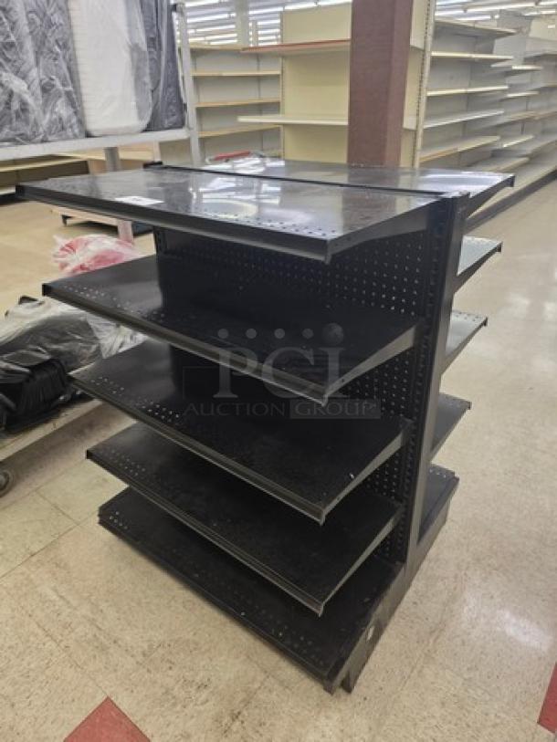 Double-sided gondola shelving unit with five adjustable black shelves on each side, used condition. Perforated back panel.
