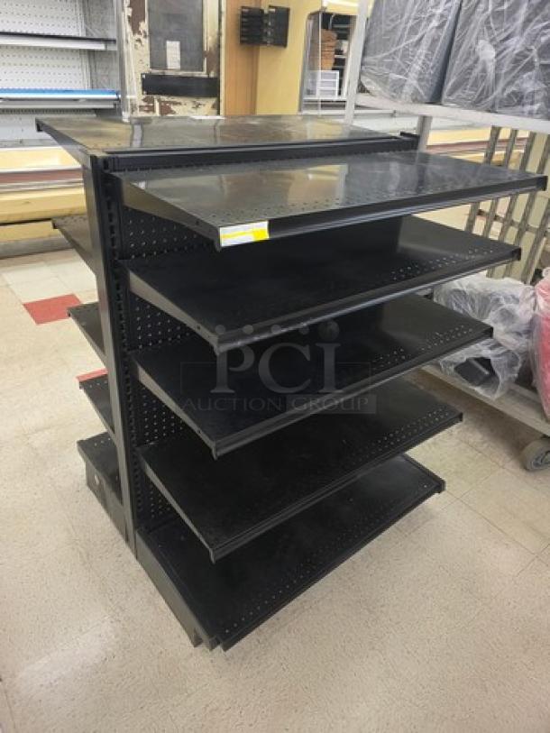 Double-sided gondola shelving unit with five black metal shelves on each side. Good condition, sturdy for retail display.