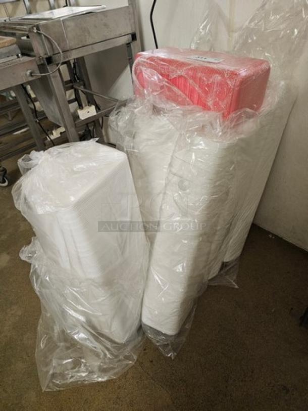 Lot of disposable food trays in plastic wrap, various sizes, new condition. Packs include white and red trays, suitable for catering.