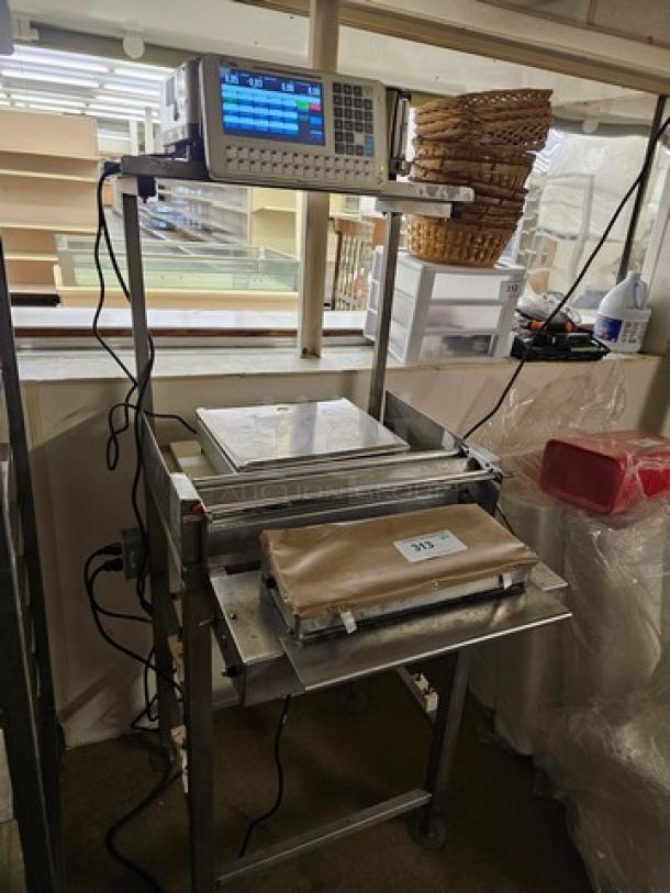 Digi SM5500B Manual Meat Wrapping Station, stainless steel, integrated digital scale, used condition.