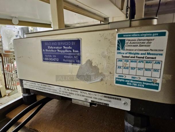 Digi SM5500B Manual Meat Wrapping Station with service labels, inspected by Virginia Dept. of Agriculture, minor wear visible.