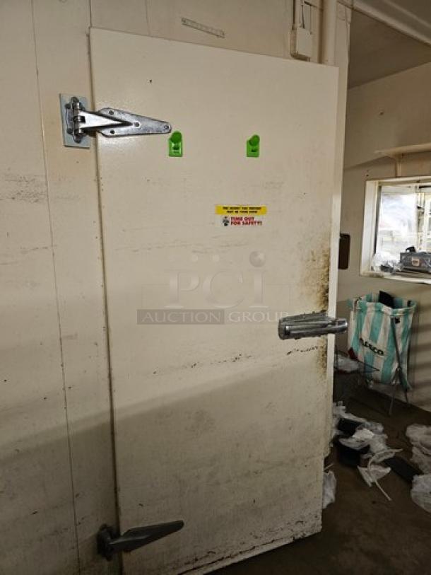 Walk-in door with hardware, white, sturdy metal hinges, and latch. Surface shows slight wear. Safety label visible.