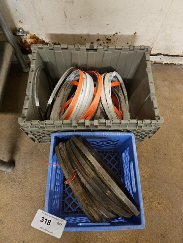 Lot of band saw blades in crates, various sizes and types. Includes used and unused blades. Auction tag numbered 318.