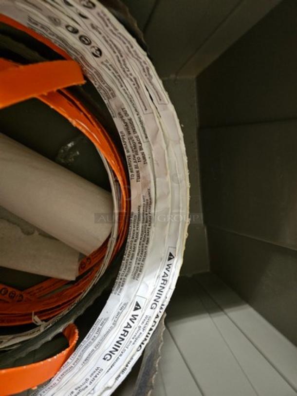 Lot of band saw blades, coiled with visible labels indicating safety warnings and usage instructions, new condition.