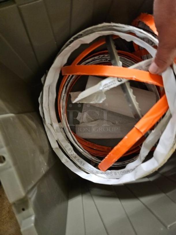 Lot of band saw blades in bin, various sizes with labels. Blades appear new. Tags indicate dimensions and specifications.