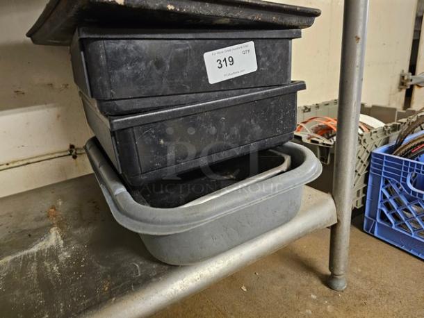 Lot of miscellaneous kitchenware, including stacked black and gray plastic bins. Visible label: "319 QTY." Used condition.