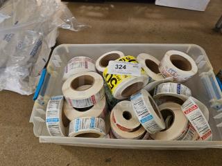 Plastic bin with assorted label rolls, various colors and prints. Lot number 324 visible on top. Ideal for organization.