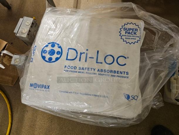 Lot of Novipax Dri-Loc food safety absorbents in original packaging. Designed for meat, poultry, seafood, and produce. Made in USA.