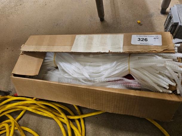 Open cardboard box containing a lot of white handy nets, used for various purposes, with labeling indicating auction lot 326.
