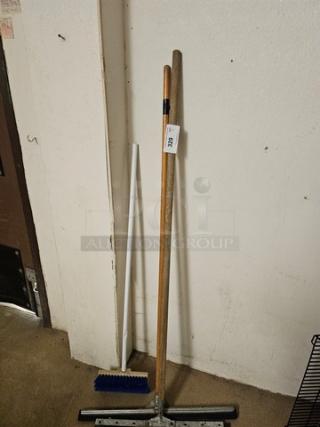 Lot of 3 miscellaneous push brooms with wooden and metal handles; good condition. Tag marked "3XBID".