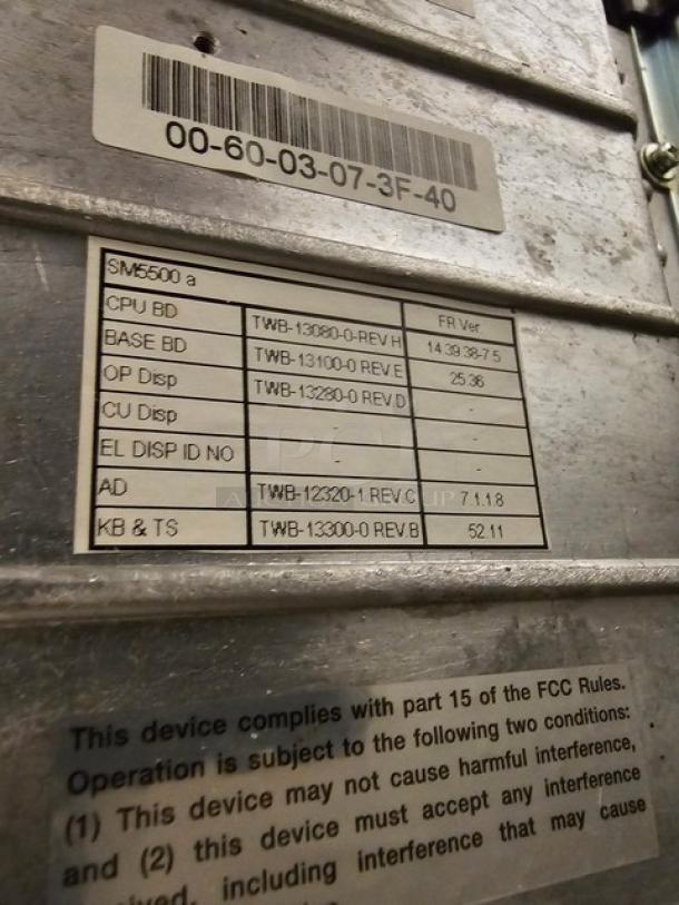 Digi SM5500a Manual Meat Wrapping Station with label detailing model parts and compliance info. In used condition.