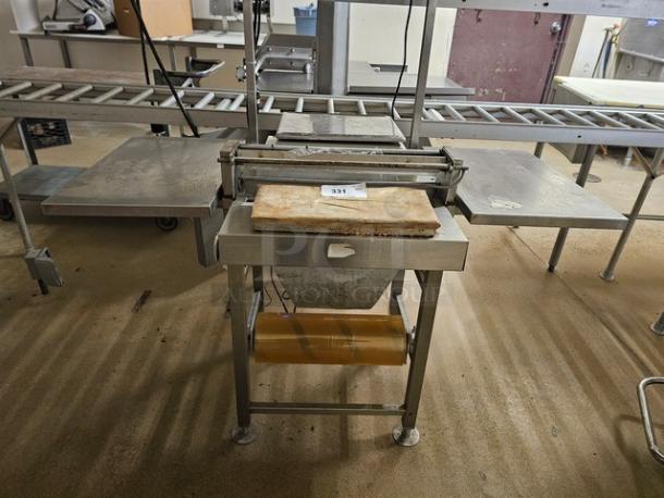 Digi SM5500a Manual Meat Wrapping Station, stainless steel, built-in roller, clean cutting surface, good condition.