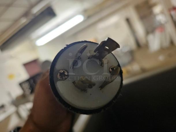 Power plug of Hobart 4246HD Meat Grinder & Mixer, 208V, 60 Hz, exposed prongs, indicating electrical specifications.