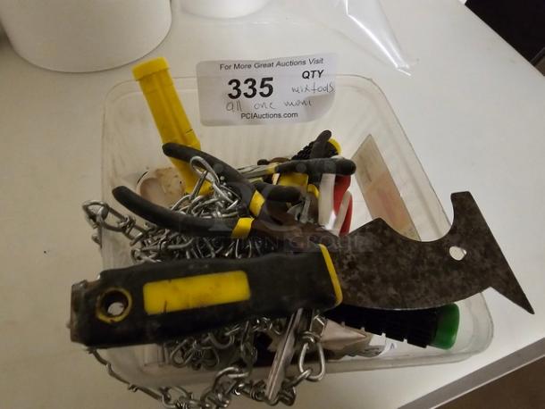 Lot of miscellaneous tools, including pliers, scraper, and metal chain, in used condition. Lot number 335 visible.