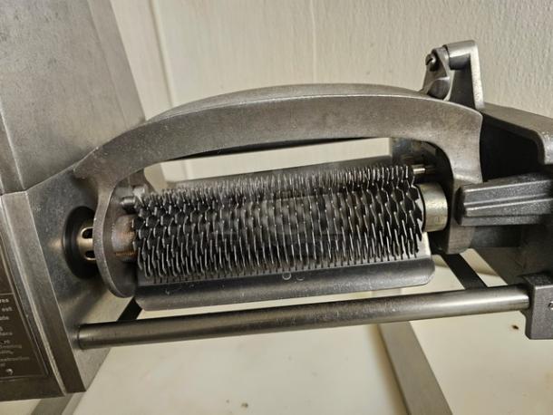 Hobart model 403 countertop meat tenderizer, featuring durable metal blades, in good condition, visible safety instructions.