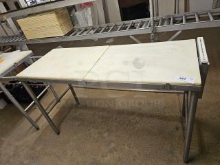 Stainless steel cutting board butcher block table with two white removable surfaces, used condition, tag labeled "341".