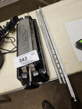 Sharpening system with metal rods and adjustable platform, lot number 343. Used condition.