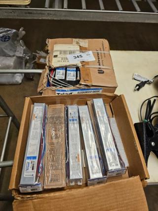 Two boxes of Universal Triad B232IUNVHP-N electronic ballasts, new condition, multiple units per box, visible packaging labels.