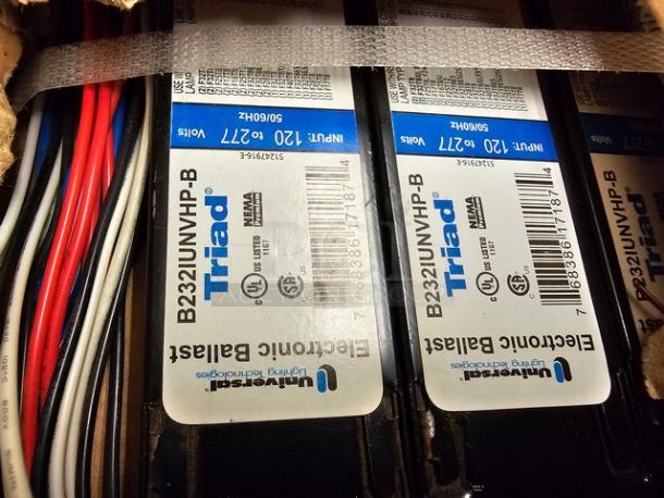 Two boxes of Universal Triad B232IUNVHP-N electronic ballasts, labeled with UL and NEMA certifications, new condition.