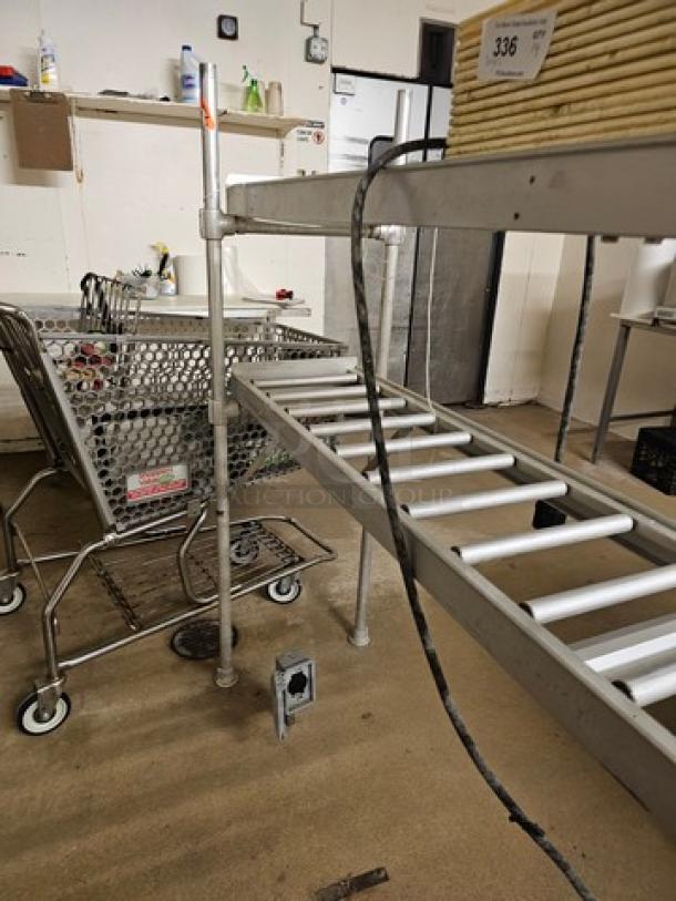 Stainless steel roller conveyor system in good condition, features metal rollers and sturdy frame. Buyer to arrange removal.