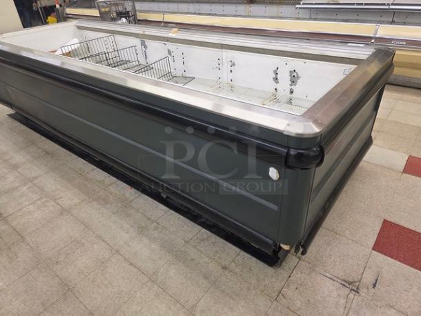 12' Hussmann LI-12U Island Case, commercial freezer, metal frame, used condition, visible interior shelving.