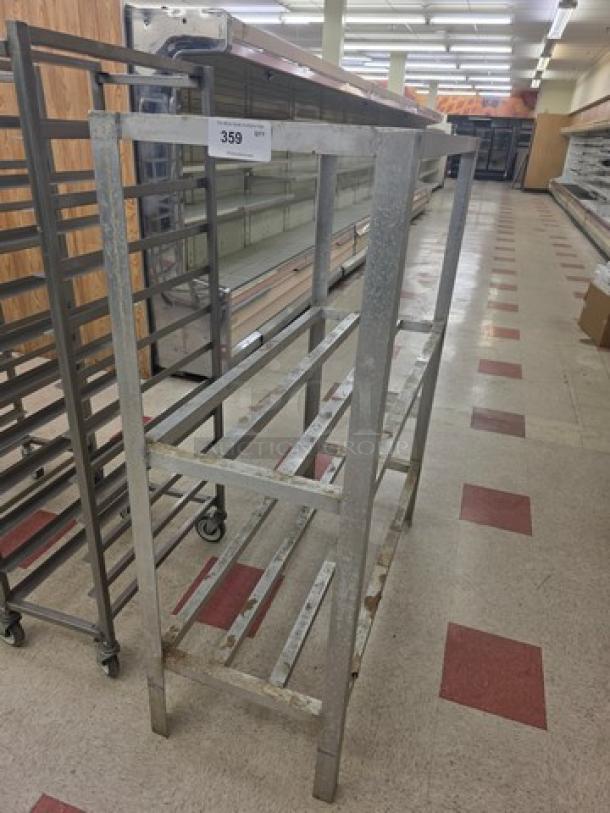 Industrial metal dunnage rack, two-tier, rectangular frame, numbered tag 359, used condition, for storage or display.