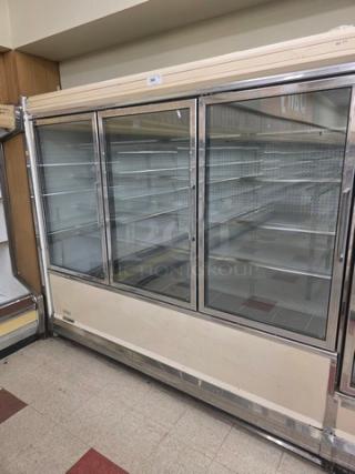 Kysor/Warren freezer display case, model LV5HF1-3U, six doors, no compressor, fair condition, shelves visible inside.