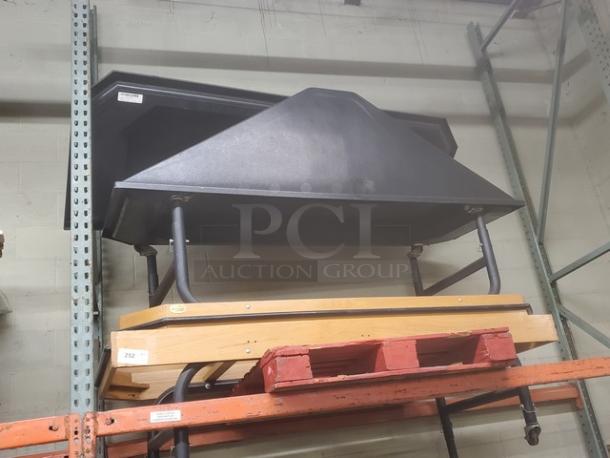 Black produce stand with steel framework, sturdy construction, suitable for displaying fruits and vegetables. Appears in good condition.