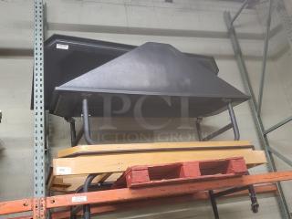 Black produce stand with steel framework, sturdy construction, suitable for displaying fruits and vegetables. Appears in good condition.