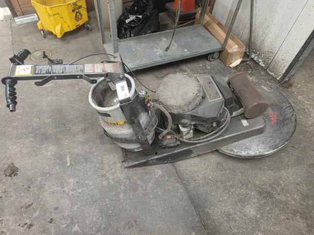 Propane-powered floor buffer in used condition, featuring a propane tank and control panel. Scratched surface. Model details unclear.
