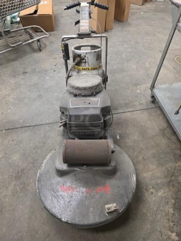 Propane-powered floor buffer, used condition, featuring handle controls and safety label. Ideal for large floor spaces.