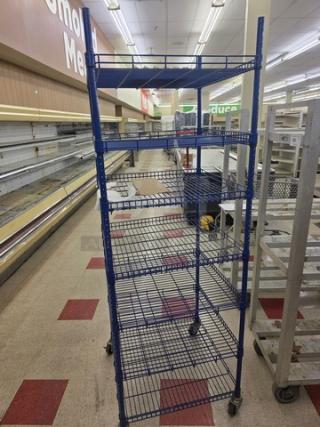 Blue wire shelving unit with multiple adjustable shelves on wheels. Suitable for storage, moderate wear, sturdy construction.