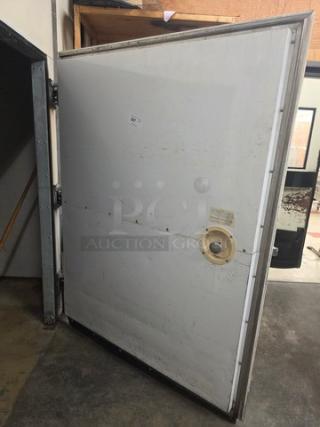 Walk-in door with hardware, worn condition, metal frame. Includes hinges and handle. Ideal for commercial installations.