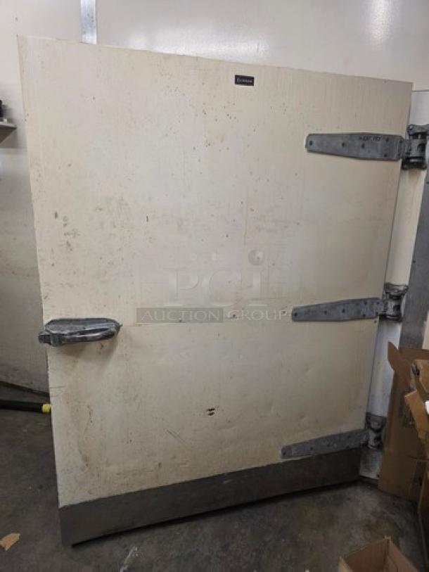 Walk-in door with hardware included, featuring metal hinges and handles, in used condition with visible wear.