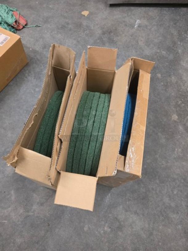 Lot of three 20'' floor scrubber pads, new, in original boxes. Two green pads and one blue pad included.