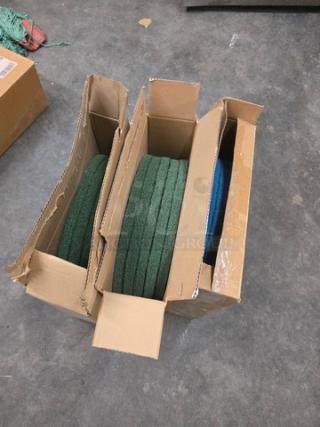 Lot of three 20'' floor scrubber pads, new, in original boxes. Two green pads and one blue pad included.