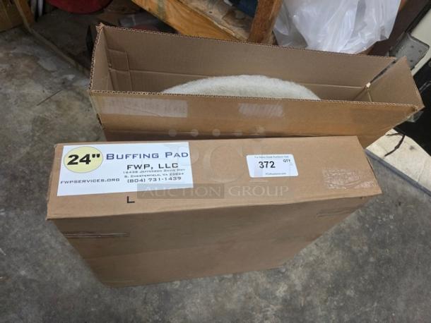 Lot of two 24" buffering pads in original boxes. Labels show "FWP, LLC" and contact info. Pads appear unused.
