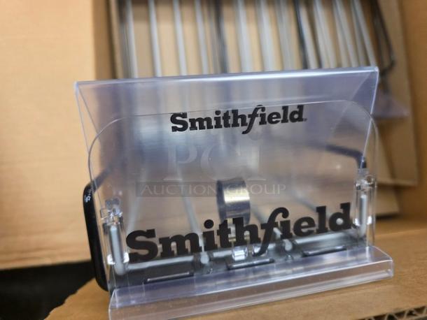 Box of Smithfield shelf top wire spring-loaded shelf pushers, new condition, features transparent plastic with logo.