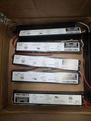Box of Power Concepts LED power supplies, model SDW-2448P-24V, new condition, visible certification markings.
