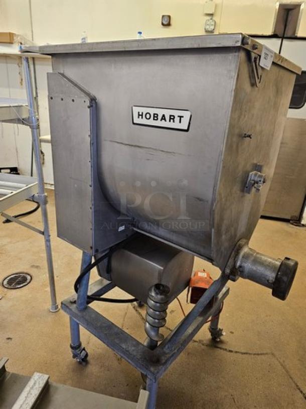 Hobart meat grinder and mixer, industrial size, stainless steel, sturdy condition. Visible Hobart brand label on the front.