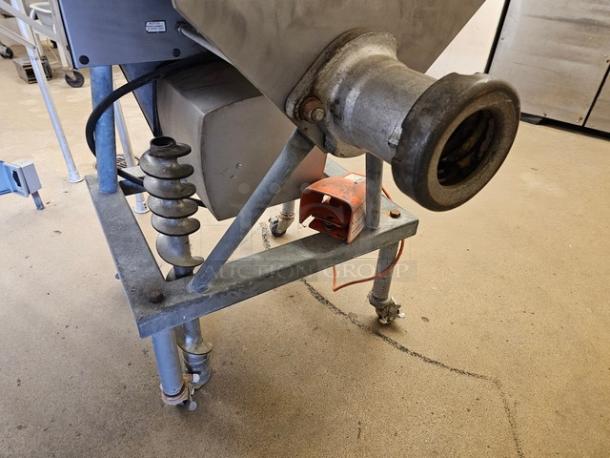 Hobart meat grinder and mixer, industrial size, features stainless steel components, sturdy frame, visible power switch.