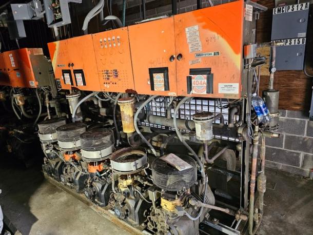 Commercial refrigeration compressor rack, low temp, using 404A refrigerant, 50 HP, visible wear, tags showing model information.